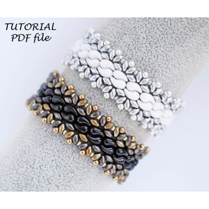 May include: Two beaded bracelets, one black and gold, the other white and silver, on a gray surface. The bracelets are made with seed beads and feature a wave-like pattern. The text "TUTORIAL PDF file" is visible in the top left corner of the image.