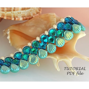 May include: A beaded bracelet with a mermaid theme, featuring iridescent blue and teal shell-shaped beads. The bracelet is accented with small white pearls and is set against a seashell. The text "TUTORIAL PDF file" is visible.