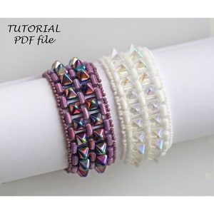 May include: Two beaded bracelets, one in iridescent purple and one in iridescent white, with a spiky design.  The bracelets are on a white surface.  The text "TUTORIAL PDF file" is at the top of the image.