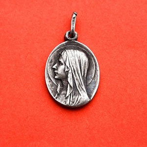 Vintage religious Catholic French silver plated medal pendant of Our Lady of Lourdes including a religious vintage prayercard of Lourdes
