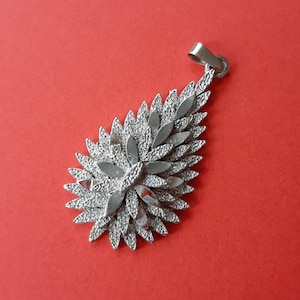 Vintage relief silver plated Sphinx pendant charm of a teardrop, numbered 1533, brutalist style pendant