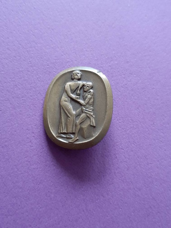 Vintage Swiss bronze Huguenin Le Locle brooch, Hug