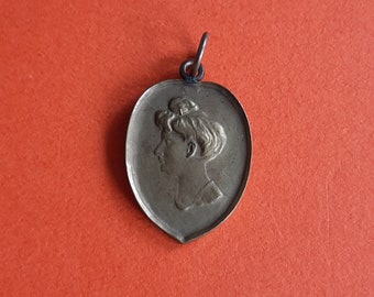 Art nouveau copper pendant charm medallion of a woman, lady whit a knot of hair, hairknot