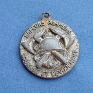 Vintage medal pendant of the French fire department, Sapeurs Pompiers Francais, old fire company medal pendant