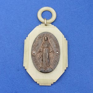Antique religious Catholic crib protector medallion with a copper Miraculous Mary medal, old baby crib protection, large old crib medal