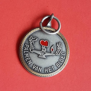 Vintage silver plated and gold toned medal pendant with text Palms of blood