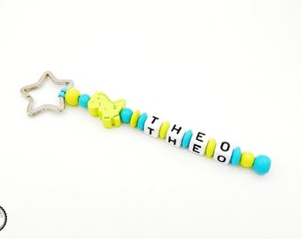 Taschenbaumler/Key fob with wish name-Dino in lemon/turquoise