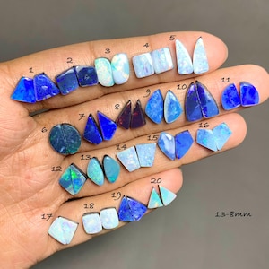 May include: A collection of twenty pairs of loose, polished opal gemstones in various shapes and colors, including shades of blue, white, and dark tones. Each pair is numbered from 1 to 20, with the text 13-8mm visible in the bottom right corner.