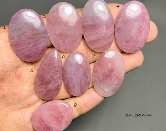 May include: Eight polished pink rose quartz cabochons in oval and teardrop shapes, numbered 1 through 8. The stones exhibit varying shades of translucent pink with natural internal inclusions. Text on the image indicates a size range of 36-30mm.