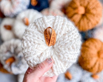 May include: White crocheted pumpkin with a brown leather tag that says "It's Fall Y'all".