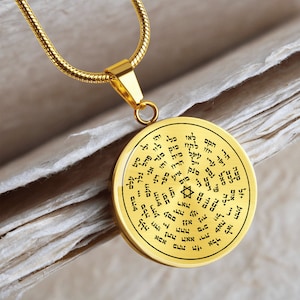 May include: A gold necklace with a round pendant featuring a Star of David and Hebrew text. The pendant is inscribed with the words "Shema Yisrael" and other Hebrew prayers.