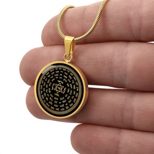 May include: A gold chain necklace with a round pendant featuring a black background and gold Hebrew text and a Star of David.