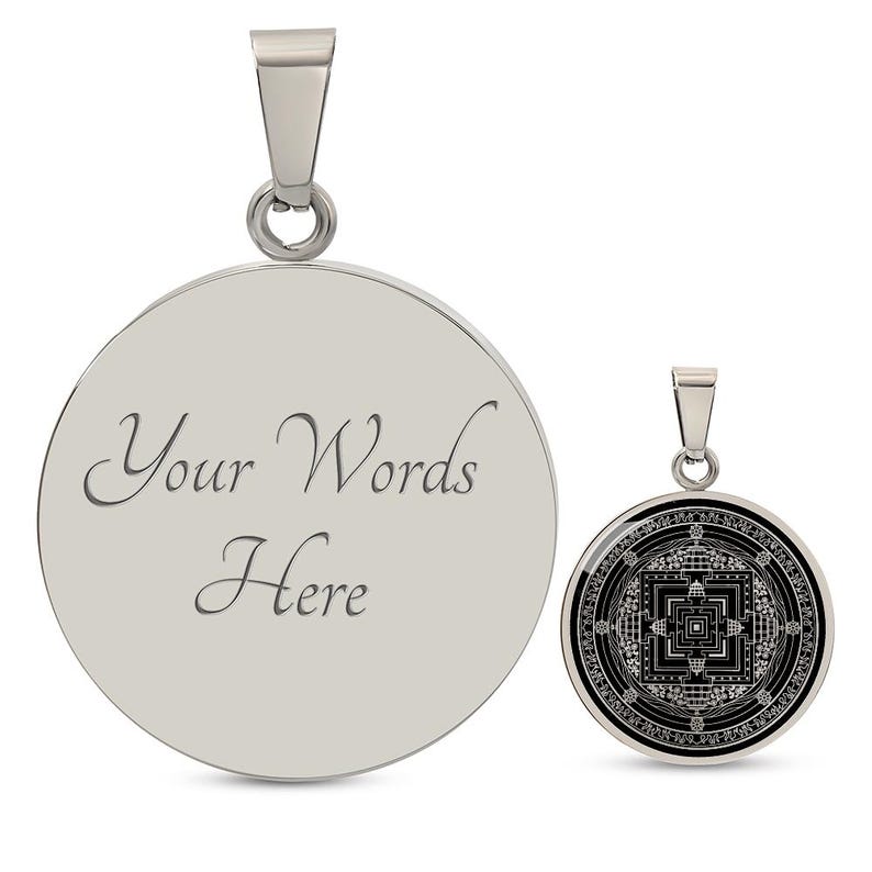 May include: Two silver pendants, one with a blank circular surface and the text "Your Words Here" engraved on it, and the other with a black and white mandala design.