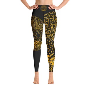 May include: Black yoga leggings with a gold tree of life design. The design features leaves, stars, and a crescent moon.