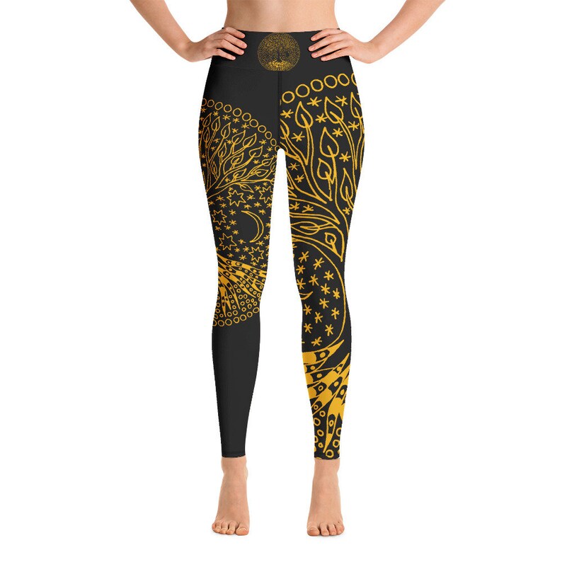 May include: Black yoga leggings with a gold tree of life design. The design features leaves, stars, and a crescent moon.