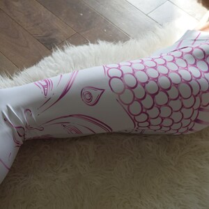 May include: White yoga leggings with a pink and white mandala design and the text "yoga yah" printed on the leg.