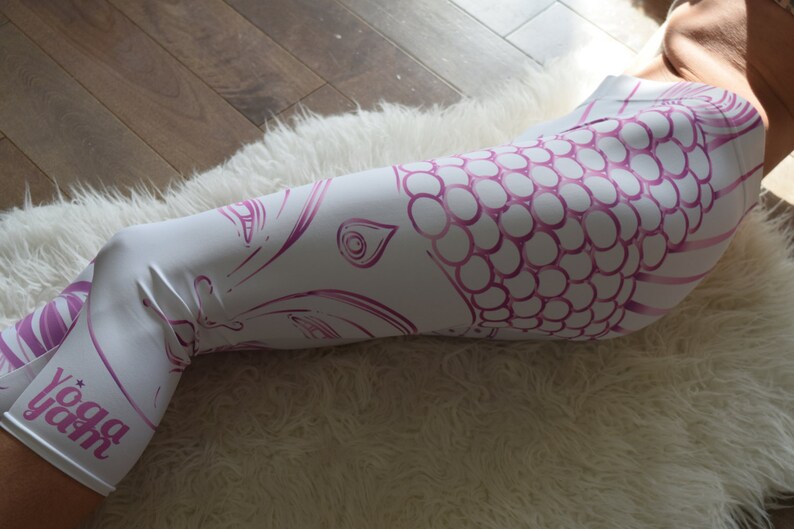 May include: White yoga leggings with a pink and white mandala design and the text "yoga yah" printed on the leg.
