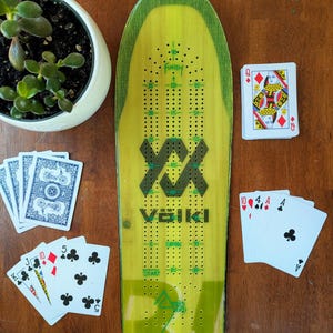 Planche de ski cribbage unique, livrée avec 9 piquets en métal et un jeu de cartes.