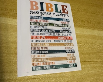 May include: A white rectangular sticker with the words "BIBLE emergency numbers" in orange and teal. Below, a list of feelings and corresponding Bible verses is printed in black, including "Feeling Sad" and "Feeling Betrayed."