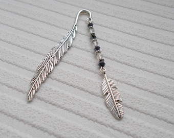 feather bookmark, a silver page holder with beads and feather charm