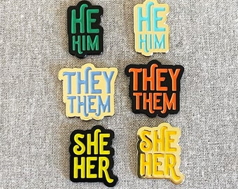 Pronoun enamel pins — He/Him, She/Her, They/Them...wear your preference with our unique designs! Pronoun gift, gender gift, DEI gift