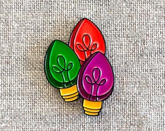 Christmas Lights enamel pin – Spread the holiday cheer with our colorful Christmas Bulbs enamel pin. Great stocking stuffer gift!