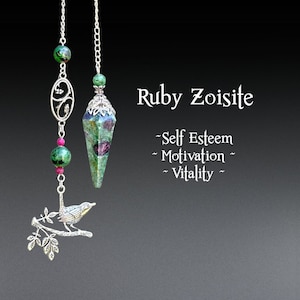 May include: Two pendants with chains. One has a faceted ruby zoisite crystal, the other has green and pink beads and a silver bird on a branch. Text reads "Ruby Zoisite" and "Self Esteem, Motivation, Vitality."