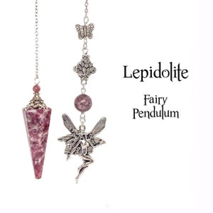 May include: Two pendulums hang against a white backdrop. One has a pink lepidolite crystal point, the other a fairy charm, a lepidolite bead, and a butterfly charm. The text reads "Lepidolite Fairy Pendulum."