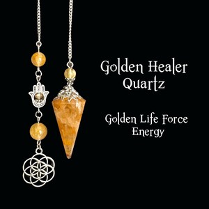 May include: Two golden quartz pendulums hang against a black background. One features a faceted crystal, the other has a Hamsa hand and a flower of life charm. Text reads "Golden Healer Quartz" and "Golden Life Force Energy."