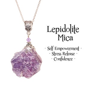 May include: A silver necklace with a raw, purple lepidolite mica pendant. The stone hangs from a decorative silver bail and chain. The image includes text stating "Lepidolite Mica" and its benefits.