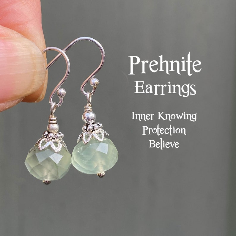 May include: Prehnite earrings with faceted, pale green gemstones and silver-tone metal accents. The earrings have a hook closure. Text on the image reads "Prehnite Earrings, Inner Knowing, Protection, Believe."