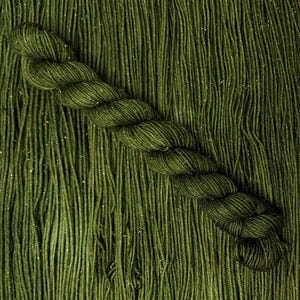 May include: A close-up of a deep green yarn with a subtle sparkle. The yarn is twisted into a braid and has a soft, fuzzy texture.
