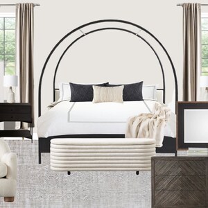 May include: A bedroom featuring a black canopy bed with white bedding and a white throw blanket. Two bedside tables with lamps, a white armchair, and a large dresser with a mirror complete the scene. The walls are white and the floor is covered in a grey rug.