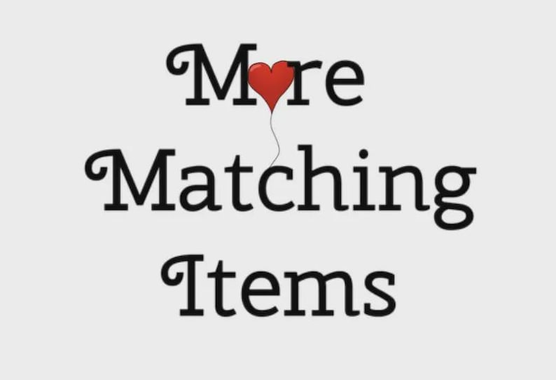 Puede incluir: Imagen con el texto "More Matching Items" en una fuente negra y elegante. Un globo rojo en forma de coraz&oacute;n flota sobre la palabra "More". El fondo es de color gris claro.