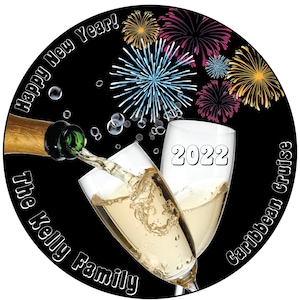 Puede incluir: Un fondo negro con una botella de champ&aacute;n que se vierte en dos copas de champ&aacute;n. Las copas chocan entre s&iacute; y el texto "2022" est&aacute; en una de las copas. El texto "Happy New Year!" est&aacute; en un c&iacute;rculo alrededor de la parte superior de la imagen. El texto "The Kelly Family Caribbean Cruise" est&aacute; en un c&iacute;rculo alrededor de la parte inferior de la imagen. Hay fuegos artificiales en el fondo.