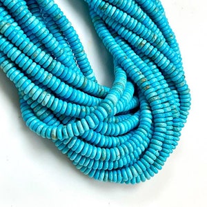 May include: A strand of turquoise blue beads, each bead is a cylinder with a slightly rounded shape. The beads are stacked on top of each other, creating a thick, rope-like strand.