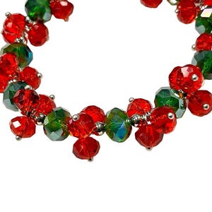 May include: A red and green beaded bracelet with a silver wire connecting the beads.