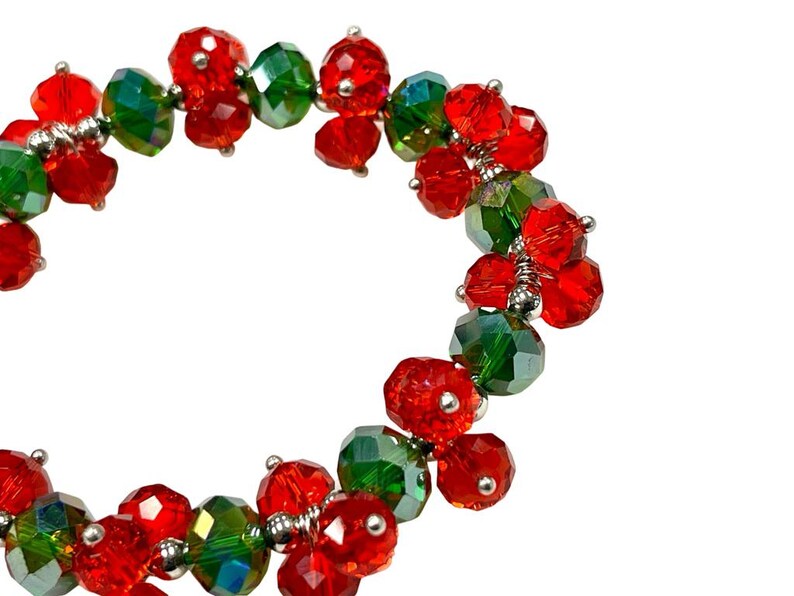 May include: A red and green beaded bracelet with a festive holiday theme.