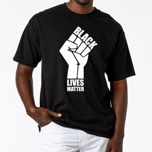 May include: Black t-shirt with a white raised fist graphic and the text "Black Lives Matter".