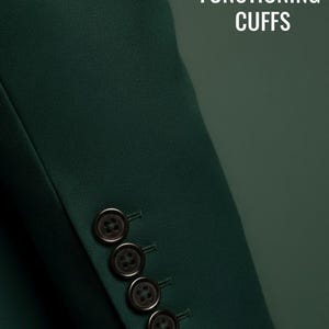 May include: A dark green blazer sleeve featuring four dark brown buttons arranged in a vertical row on the cuff. The text BESPOKE FUNCTIONING CUFFS is printed in white capital letters in the upper right corner of the image.