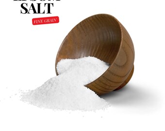 May include: A wooden bowl overflowing with fine grain Epsom salt, spilling onto a white surface. The bowl is tipped over, with the salt cascading out. The text "EPSOM SALT FINE GRAIN" is visible in the top left corner of the image. The text "Aroma Depot" is visible in the bottom right corner of the image.