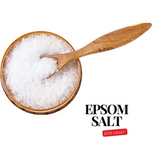 May include: A wooden spoon scoops white Epsom salt from a wooden bowl. The text "EPSOM SALT FINE GRAIN" is printed below the bowl.