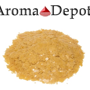 May include: A close-up of a pile of light brown wax flakes. The wax is used for making candles and other crafts.