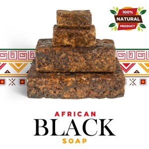 May include: A stack of four brown African black soap bars, with the words "100% NATURAL PRODUCT" in a green circle with red text and green leaves on the right side of the image. The soap bars are stacked in a pyramid shape, with the largest bar at the bottom and the smallest bar at the top. The soap bars are rough and textured, and they have a dark brown color. The background is white.