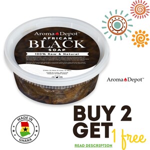 May include: A white plastic container of African Black Soap, labeled "Aroma Depot™ African Black Soap 100% Raw & Natural". The soap is dark brown and has a rough texture. The container is sitting on a white surface. The text "BUY 2 GET 1 free" is written in black and yellow letters on a white background. The text "READ DESCRIPTION" is written in black letters on a green background.