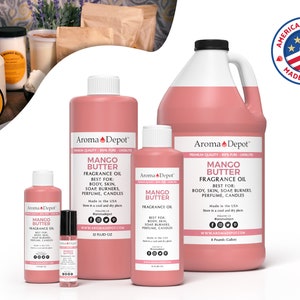 May include: A set of four bottles of mango butter fragrance oil in various sizes. The bottles are pink and have a white label with the text "Aroma Depot" and "Mango Butter Fragrance Oil". The bottles are arranged in a row from largest to smallest. The largest bottle is a gallon size, the next is 32 fluid ounces, the next is 10 fluid ounces, and the smallest is a 10 ml roll-on bottle. The bottles are all labeled "Made in the USA".