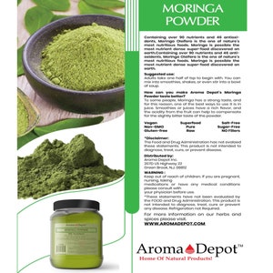 May include: A green jar of Moringa Powder with a white label that reads "Aroma Depot Moringa Powder". The label also includes the text "Home of Natural Products!" and a logo of a red heart with a green leaf. The jar is sitting on a wooden surface.