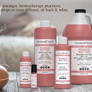 May include: Five bottles of Mango Butter fragrance oil in various sizes, from a small 10 ml bottle to a large 32 fl oz bottle. The bottles are all pink and have a white label with the text "Aroma Depot" and "Mango Butter Fragrance Oil". The bottles are arranged on a wooden surface with a diffuser in the background.
