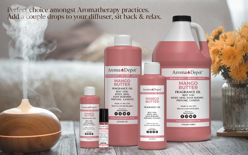 May include: Five bottles of Mango Butter fragrance oil in various sizes, from a small 10 ml bottle to a large 32 fl oz bottle. The bottles are all pink and have a white label with the text "Aroma Depot" and "Mango Butter Fragrance Oil". The bottles are arranged on a wooden surface with a diffuser in the background.