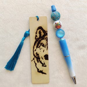 A set of creations for birthday gifts or other gifts. A decorated pen and a wooden bookmark. Handmade gifts at low prices.